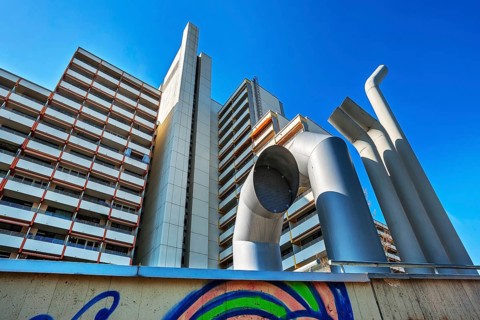 High-rise building with concrete balconies and ventilation pipes