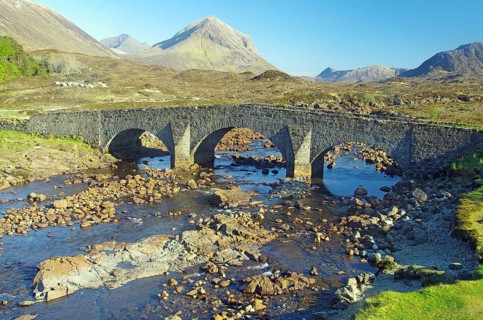 Old stone bridge leading over a stream