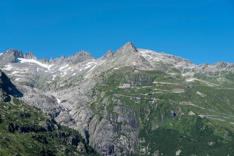Mountain massif of the Rhone glacier with serpentines of the Furka Pass road