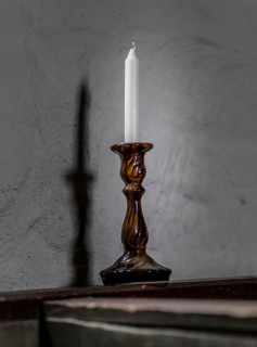 Candlestick with white candle in a church