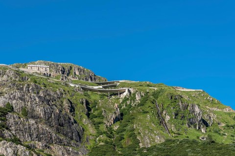 Mountain massif of the Rhone glacier with serpentines of the Furka Pass road