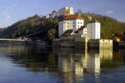 Veste Oberhaus reflected in the Danube on a calm winter morning