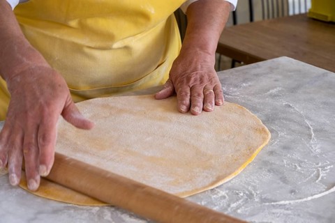 Woman rolling pasta dough