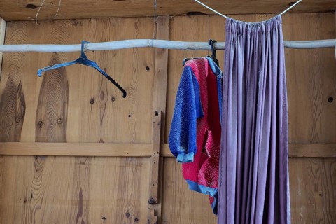 Empty wooden cupboard with curtain