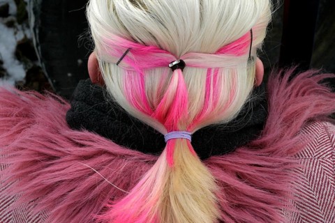 Blonde woman with pink hair and coat with pink fur collar
