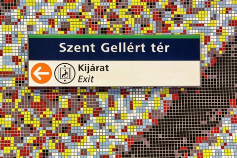 Sign with lettering Szent Gellert ter on colourful wall with mosaic