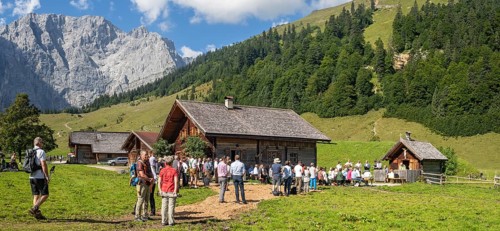 Mass celebration on Almkirtag in front of the wooden chapel in the alpine village of Eng