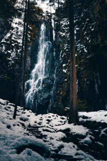 The Burgbach waterfall in winter with snow and ice