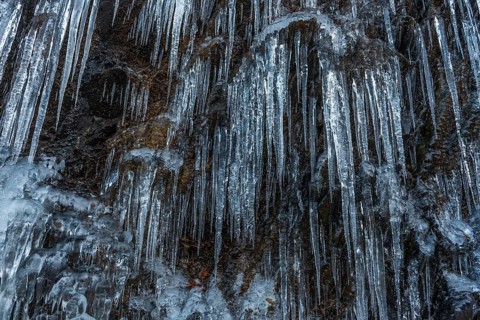 Icicles forming an icefall in the mountain in winter. France