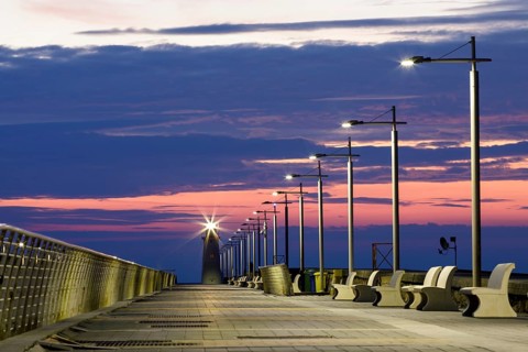 Sunrise with lighthouse at the harbour pier in Porto Maurizio