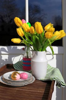 Bouquet of tulips and Easter eggs on a balcony