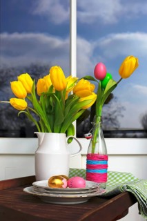 Bouquet of tulips and Easter eggs on a balcony