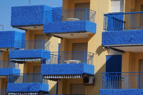 Blue balconies of a hotel complex with white-blue awnings