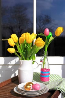 Bouquet of tulips and Easter eggs on a balcony