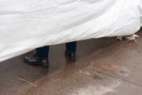 Shoes of a man behind a screen