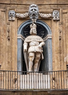 Statue of King Philip III on facade of Quattro Canti