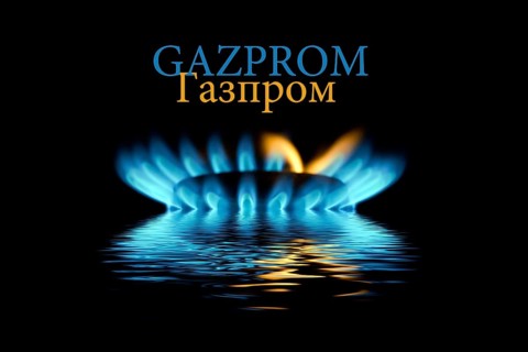 Gas flame with Gazprom logo reflected in the water