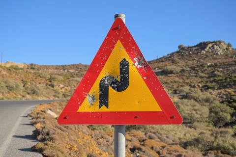 Shattered road sign