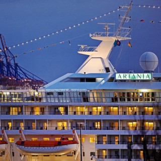 Cruise ship Artania at Hamburg Cruise Center Altona with the cranes of the harbour in the background