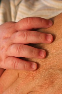 Baby hand on adult hand