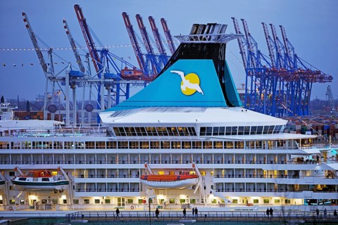 Cruise ship Artania at Hamburg Cruise Center Altona with the cranes of the harbour in the background