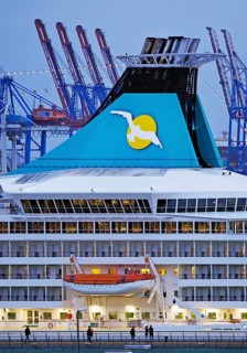 Cruise ship Artania at Hamburg Cruise Center Altona with the cranes of the harbour in the background