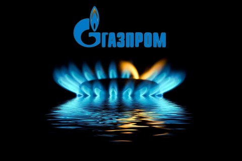 Gas flame with Gazprom logo reflected in the water