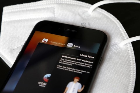 FFP2 mask and iPhone with Corona warning app and Luca app