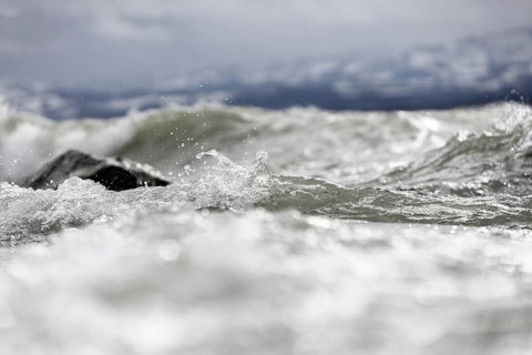 Storm Lolita raging on the rocky shore with waves in Hagnau