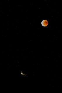 Lunar eclipse over the mountain station of the Saentisbahn