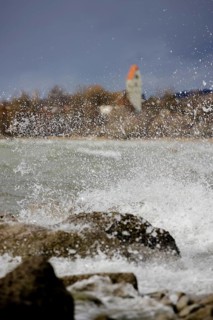 Storm Lolita whips waves against the stony shore in the background Hagnau