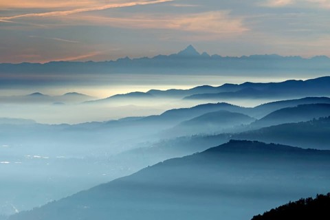 View from Pizzoni di Laveno on silhouettes of mountain ranges with Monte Viso in the distance
