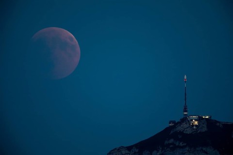 Lunar eclipse above the mountain station of Hohen Kasten