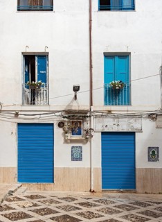 Blue doors and windows on white facade