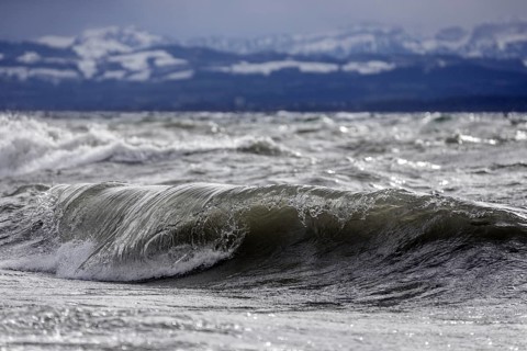 Storm Lolita raging on the rocky shore with waves in Hagnau