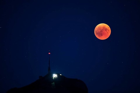 Lunar eclipse above the mountain station of Hohen Kasten