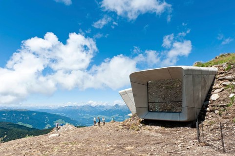 Two large futuristic windows rise out of the mountain