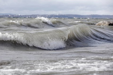 Storm Lolita raging on the rocky shore with waves in Hagnau