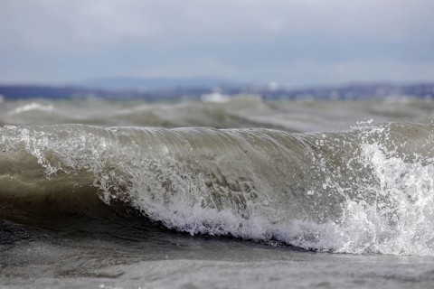 Storm Lolita raging on the rocky shore with waves in Hagnau