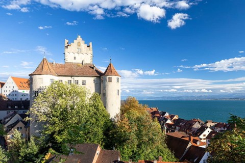 Meersburg Castle in the sunshine with a view of the Alps