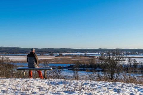 Hiker on a bench in the snow