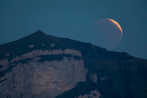 Lunar eclipse above the mountain station of Hohen Kasten