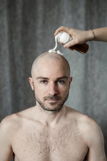 Man gets shaving foam sprayed on his bald head
