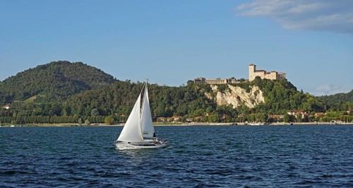 Sailing boat and castle of Angera or Rocca Borromeo di Angera