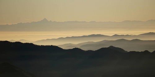 View from Pizzoni di Laveno on silhouettes of mountain ranges with Monte Viso in the distance