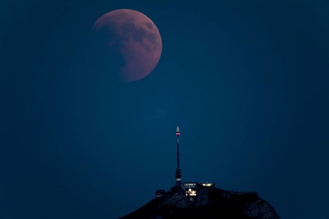 Lunar eclipse above the mountain station of Hohen Kasten