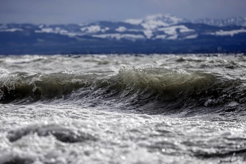 Storm Lolita raging on the rocky shore with waves in Hagnau