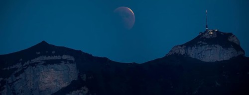 Lunar eclipse above the mountain station of Hohen Kasten