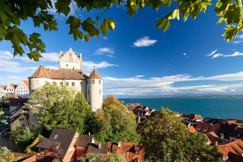 Meersburg Castle in the sunshine with a view of the Alps