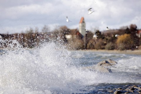 Storm Lolita whips waves against the stony shore in the background Hagnau